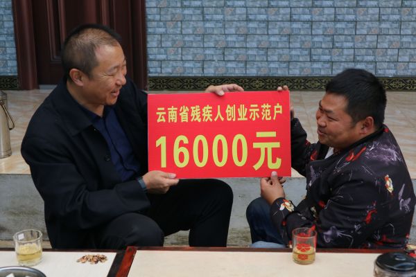 宋书记为周新伟发放残疾人创业示范户补助金